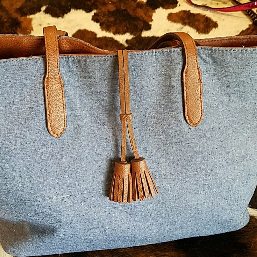 Denim and faux brown tassel and leather handles